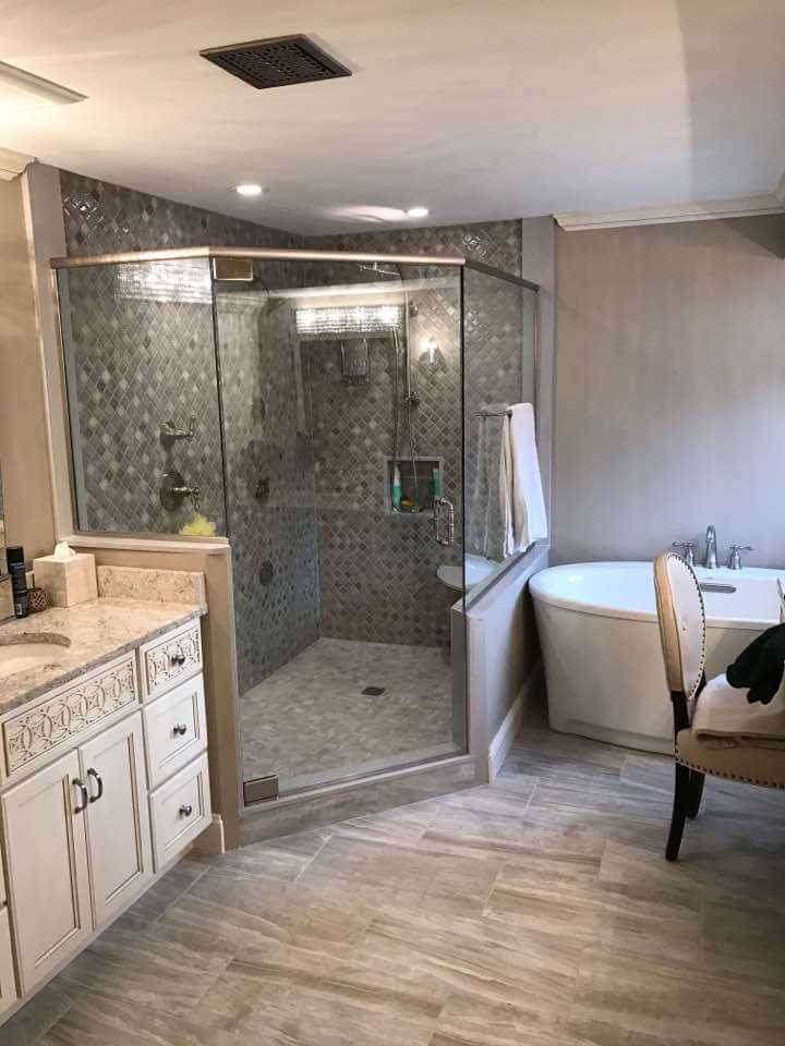 A corner glass shower enclosure maximizing the space available